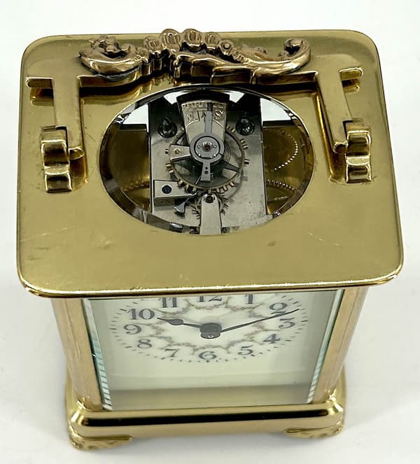 Stunning antique Victorian carriage clock. A Collectors piece, it displays very well with its original finish case and wonderfully clean white enamel dial with charming floral decoration.