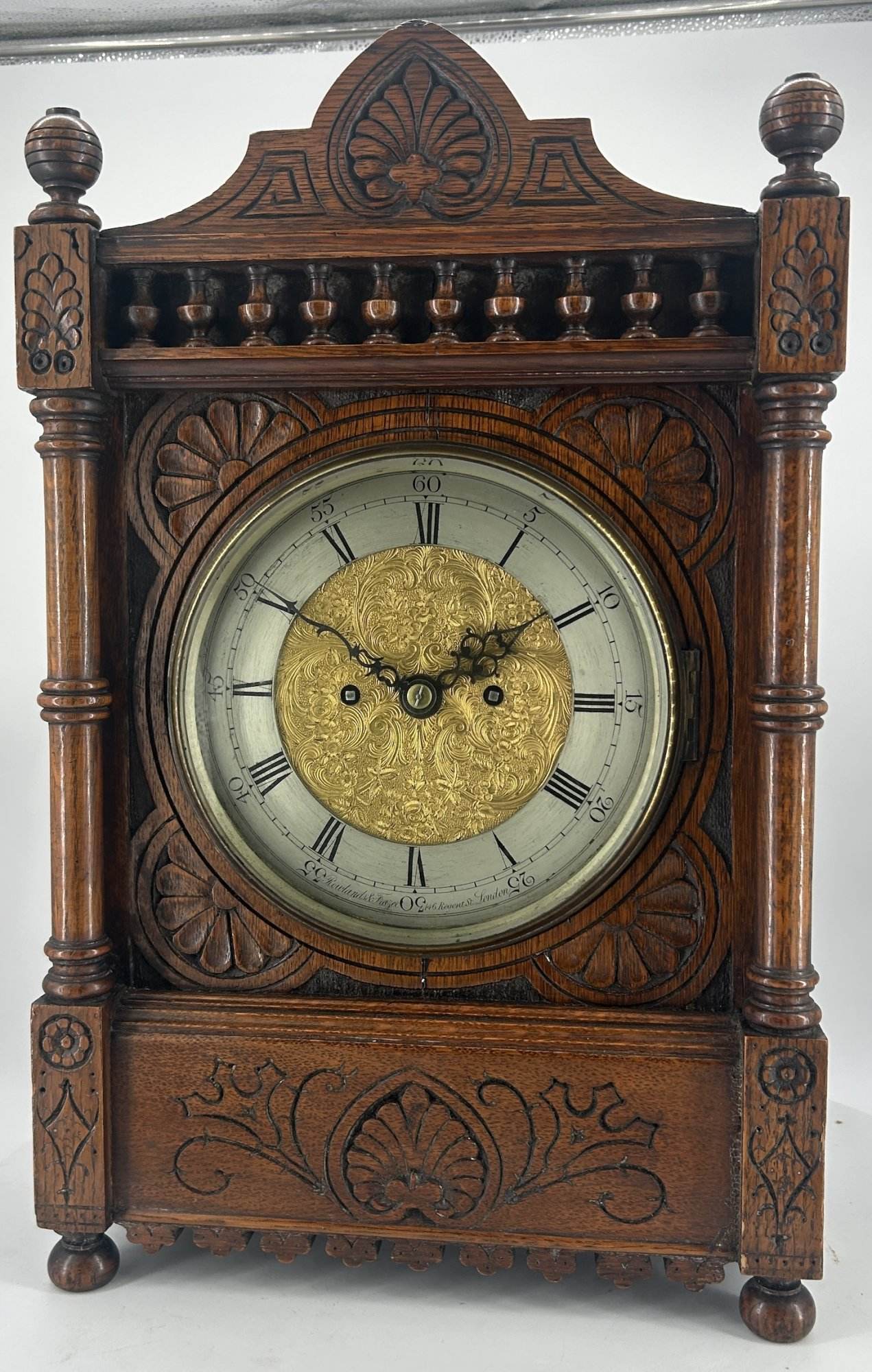 Victorian Carved oak bracket clock ca 1840. Wonderful original silver dial with a stunning ormolu detailed center piece, wonderful carved case with beautiful finials and bun feet all original to the period.