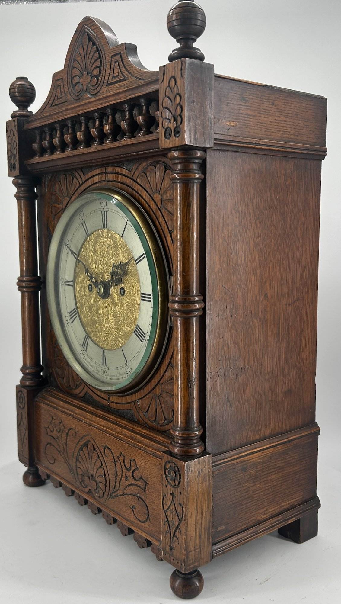 Victorian Carved oak bracket clock ca 1840. Wonderful original silver dial with a stunning ormolu detailed center piece, wonderful carved case with beautiful finials and bun feet all original to the period.